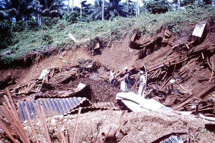 1960 Dec - Digging up building material from army dump Banika